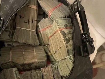 Stacks of cash packed into a bag